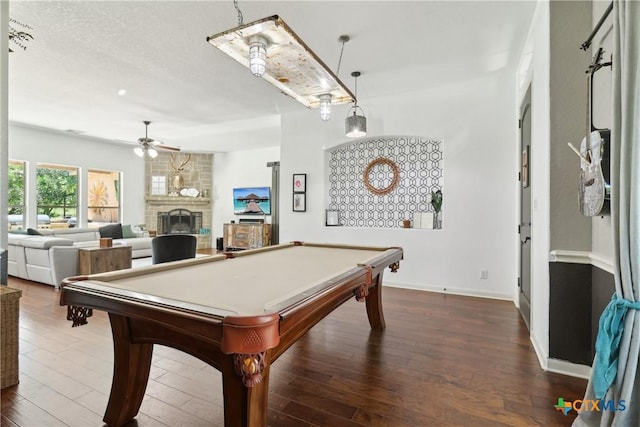 recreation room with a ceiling fan, wood finished floors, billiards, a large fireplace, and baseboards