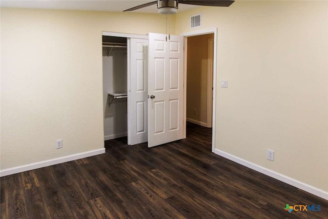 unfurnished bedroom with dark hardwood / wood-style flooring, ceiling fan, and a closet