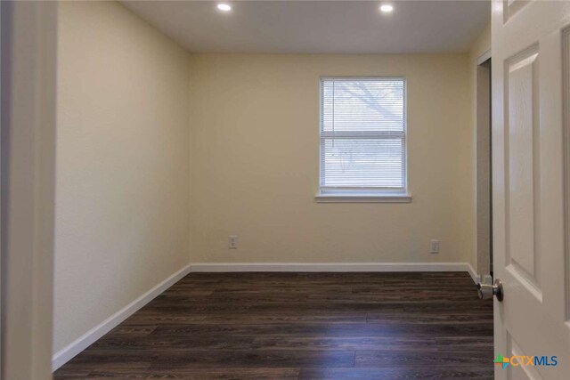 unfurnished bedroom with dark hardwood / wood-style flooring