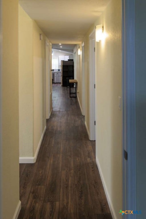 hallway featuring dark wood-type flooring