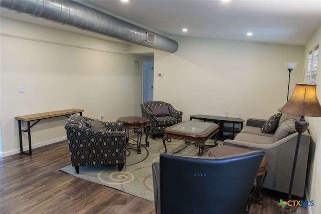 living room featuring dark wood-type flooring and lofted ceiling