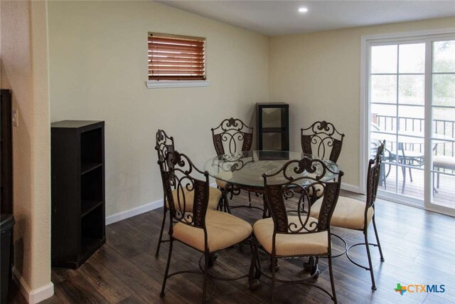 dining room featuring dark wood-type flooring and vaulted ceiling