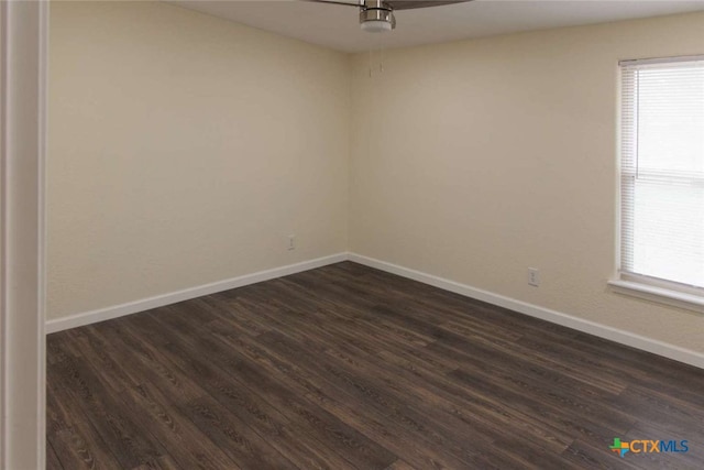 empty room with dark wood-type flooring and ceiling fan