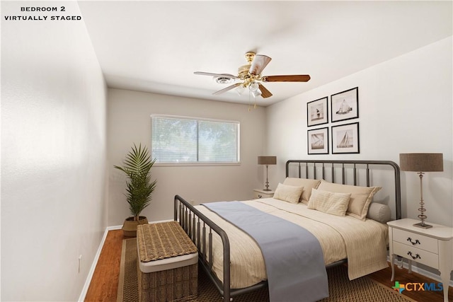 bedroom with dark wood-type flooring and ceiling fan