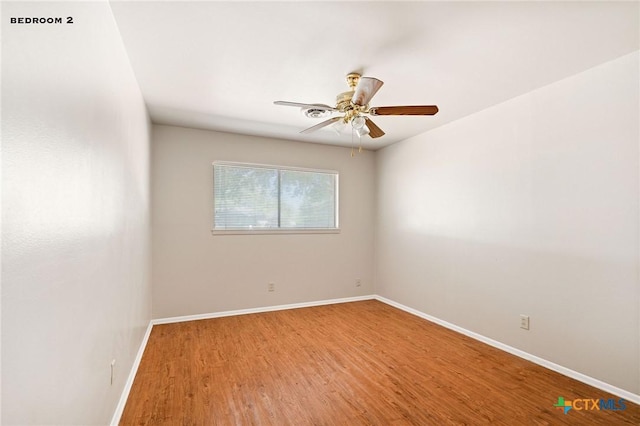 unfurnished room featuring hardwood / wood-style flooring and ceiling fan