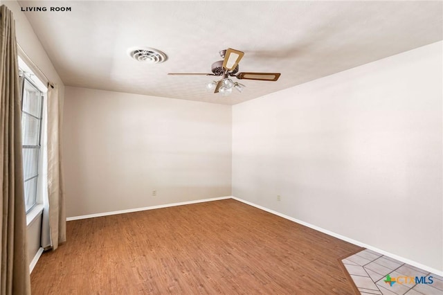 unfurnished room with hardwood / wood-style floors and ceiling fan