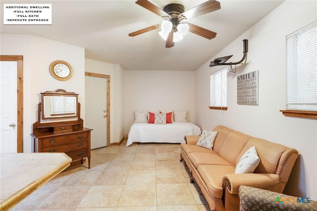 bedroom with ceiling fan and light tile patterned floors