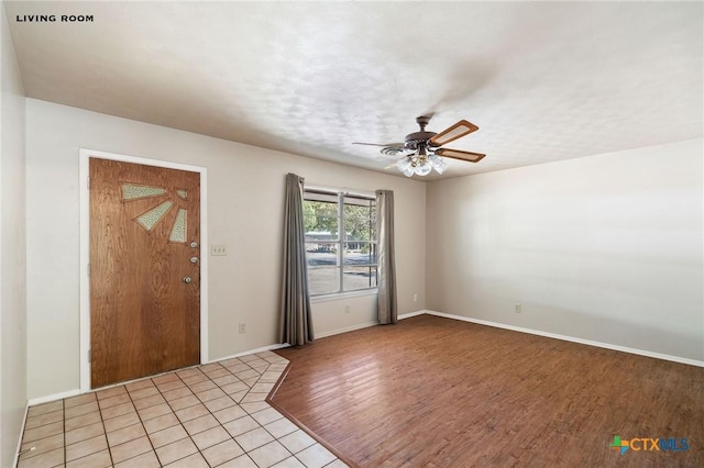 entryway with ceiling fan and light hardwood / wood-style flooring