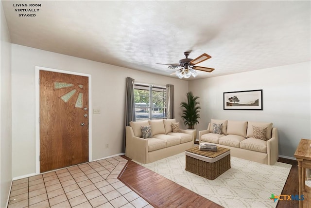 tiled living room featuring ceiling fan