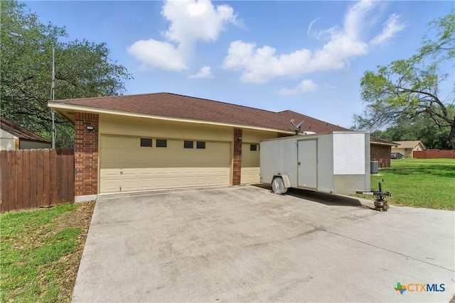 1233 Oakcrest Dr, Pleasanton, TX 78064 - view of front facade featuring brick siding, concrete driveway, an attached garage, and an outdoor structure