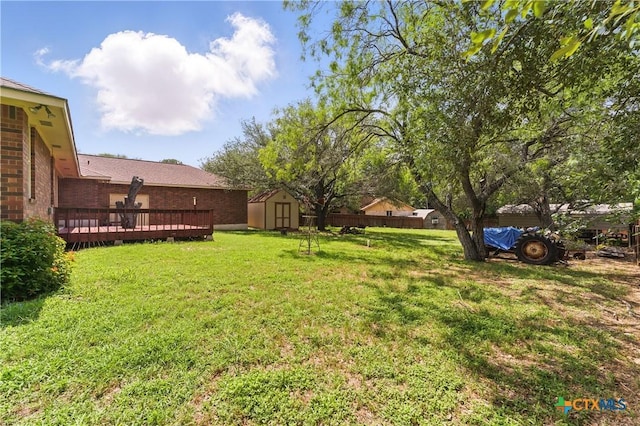 1233 Oakcrest Dr, Pleasanton, TX 78064 - view of grassy yard featuring a storage shed and a wooden deck