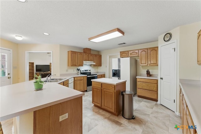 1233 Oakcrest Dr, Pleasanton, TX 78064 - kitchen with white appliances, under cabinet range hood, light countertops, a peninsula, and a textured ceiling