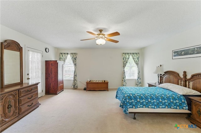 1233 Oakcrest Dr, Pleasanton, TX 78064 - bedroom with carpet flooring, a textured ceiling, and ceiling fan