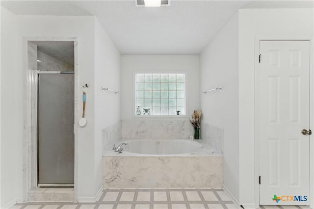 1233 Oakcrest Dr, Pleasanton, TX 78064 - full bathroom featuring a stall shower, a garden tub, and tile patterned floors