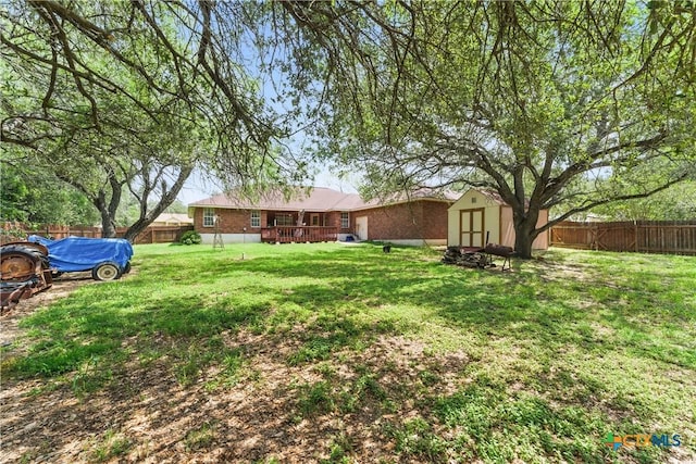1233 Oakcrest Dr, Pleasanton, TX 78064 - fenced backyard featuring a shed and a deck