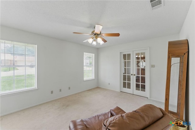 1233 Oakcrest Dr, Pleasanton, TX 78064 - carpeted living area featuring french doors and a ceiling fan