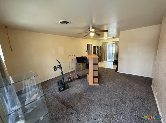 workout room featuring carpet floors, a ceiling fan, and visible vents