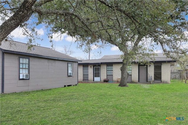 back of property with cooling unit and a yard