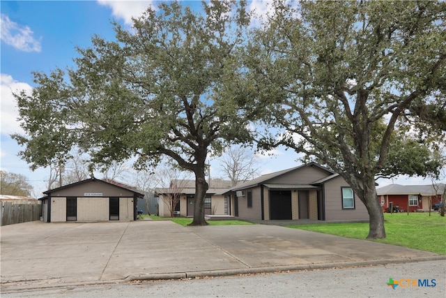 ranch-style home with a front yard and a garage