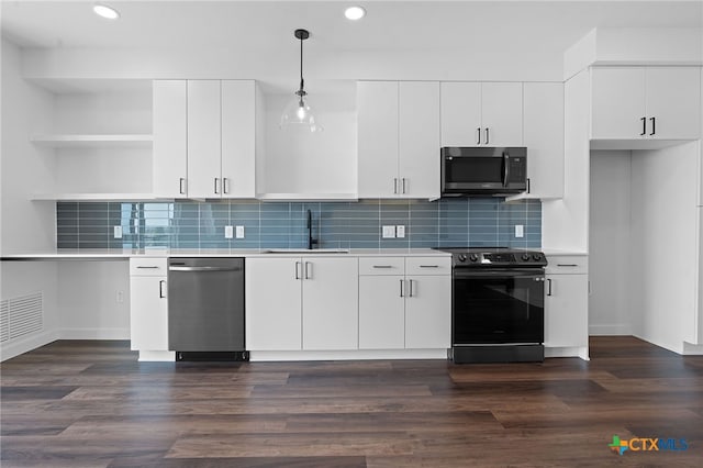 kitchen featuring decorative light fixtures, sink, white cabinetry, and stainless steel appliances