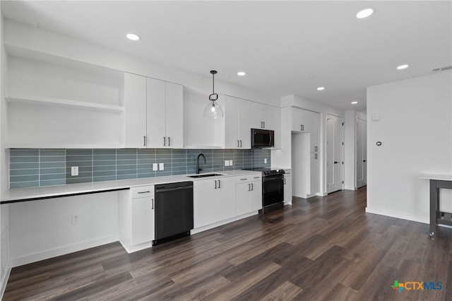 kitchen with black appliances, white cabinetry, hanging light fixtures, and dark wood-type flooring