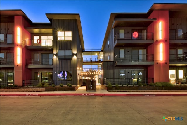 view of outdoor building at dusk