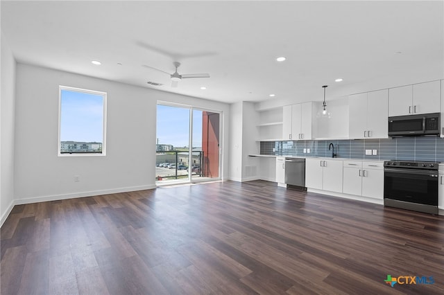 kitchen featuring appliances with stainless steel finishes, backsplash, sink, white cabinets, and dark hardwood / wood-style floors