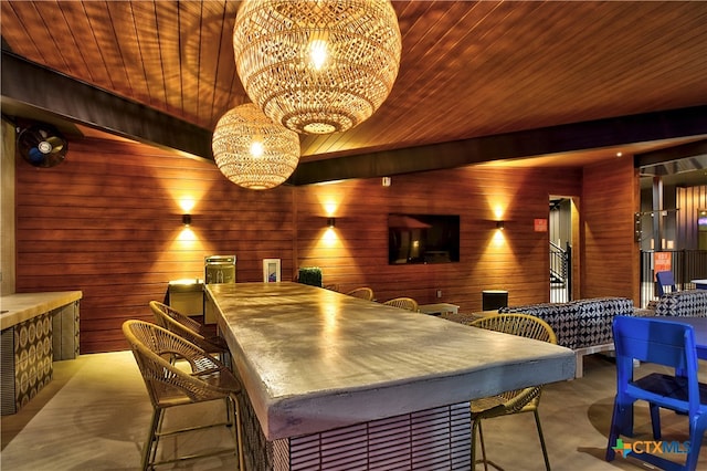 home theater room with wood walls, wooden ceiling, lofted ceiling, and a notable chandelier