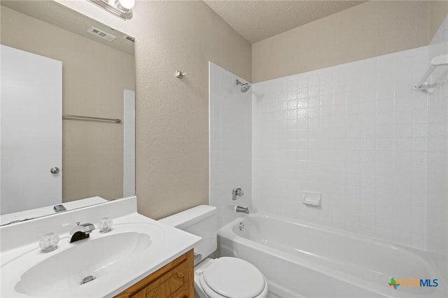 3317 Westrim Dr, Killeen, TX 76549 - full bath with toilet, vanity, bathtub / shower combination, a textured wall, and a textured ceiling