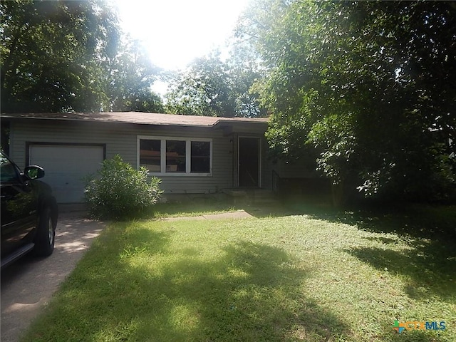 ranch-style home featuring a garage and a front yard