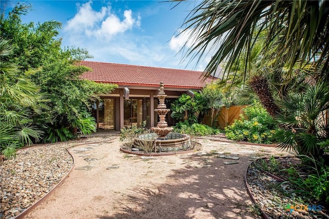 1809 W Harrison Ave, Port Oconnor, TX 77982 - rear view of property featuring a tiled roof