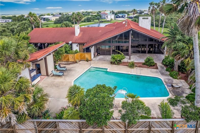 1809 W Harrison Ave, Port Oconnor, TX 77982 - swimming pool with a water slide, a patio area, and a fenced backyard