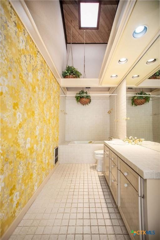 1809 W Harrison Ave, Port Oconnor, TX 77982 - bathroom with wallpapered walls, a garden tub, vanity, tile patterned floors, and recessed lighting