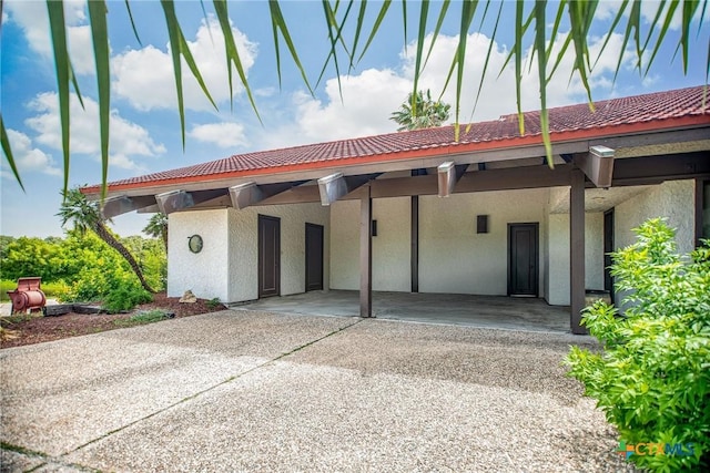 1809 W Harrison Ave, Port Oconnor, TX 77982 - exterior space with a tile roof and stucco siding