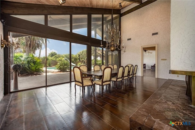 1809 W Harrison Ave, Port Oconnor, TX 77982 - dining room with a textured wall, a wood ceiling with exposed beams, high vaulted ceiling, and a chandelier