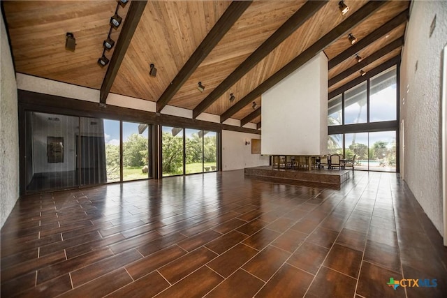 1809 W Harrison Ave, Port Oconnor, TX 77982 - unfurnished living room featuring rail lighting, a wooden ceiling with exposed beams, and high vaulted ceiling
