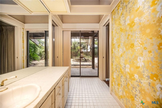 1809 W Harrison Ave, Port Oconnor, TX 77982 - bathroom with wallpapered walls, vanity, and tile patterned flooring