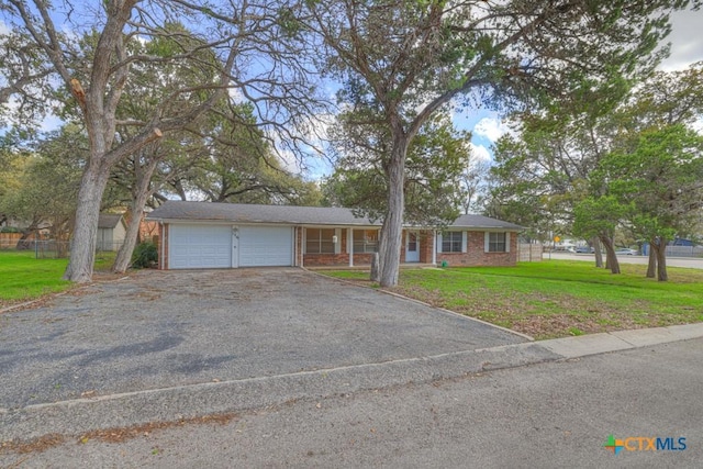 single story home with a garage and a front yard