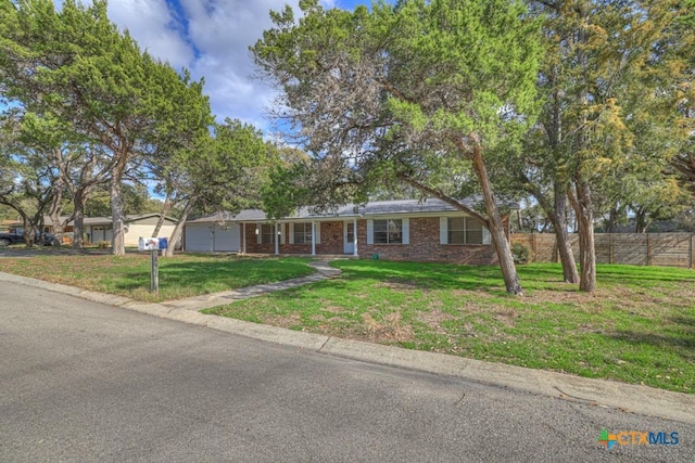 ranch-style house with a garage and a front yard