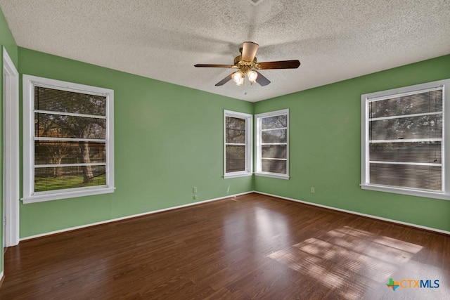 spare room featuring hardwood / wood-style flooring, a textured ceiling, and ceiling fan