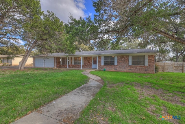 single story home featuring a garage and a front lawn