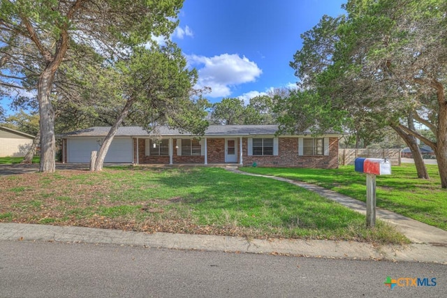 single story home featuring a garage and a front lawn