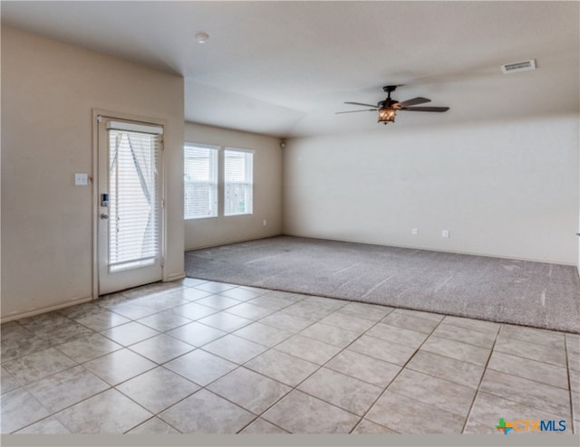 1413 Doncaster Dr, Seguin, TX 78155 - spare room featuring light tile patterned flooring, visible vents, a ceiling fan, and light carpet