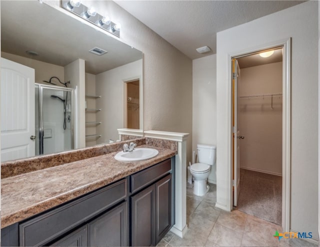 1413 Doncaster Dr, Seguin, TX 78155 - bathroom featuring vanity, a walk in closet, toilet, a stall shower, and visible vents