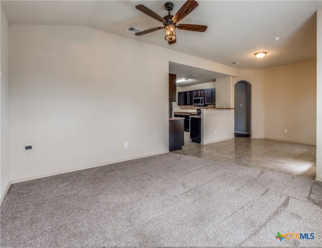 1413 Doncaster Dr, Seguin, TX 78155 - unfurnished living room featuring arched walkways, light carpet, ceiling fan, and visible vents