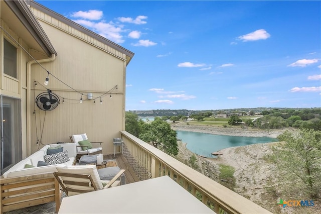 balcony featuring outdoor lounge area and a water view