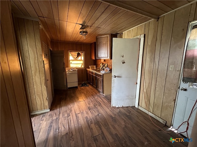 kitchen with dark wood-style flooring, stove, wood ceiling, wooden walls, and light countertops
