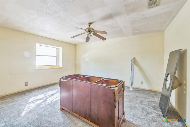 home office with light carpet and ceiling fan