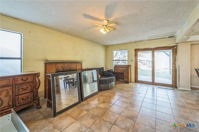 interior space featuring ceiling fan and light tile patterned floors