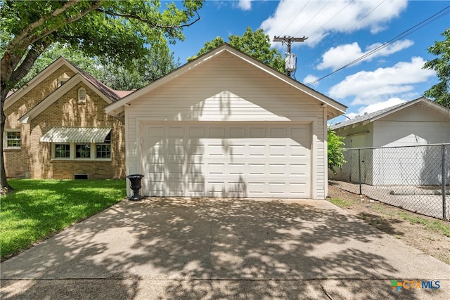 exterior space with a garage and a front yard